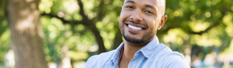 Smiling man outdoors.