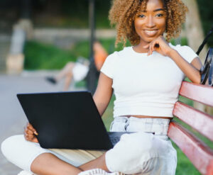 Smilling student working on laptop