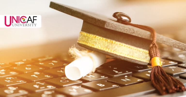 Business Degree under Graduation Cap on Keyboard